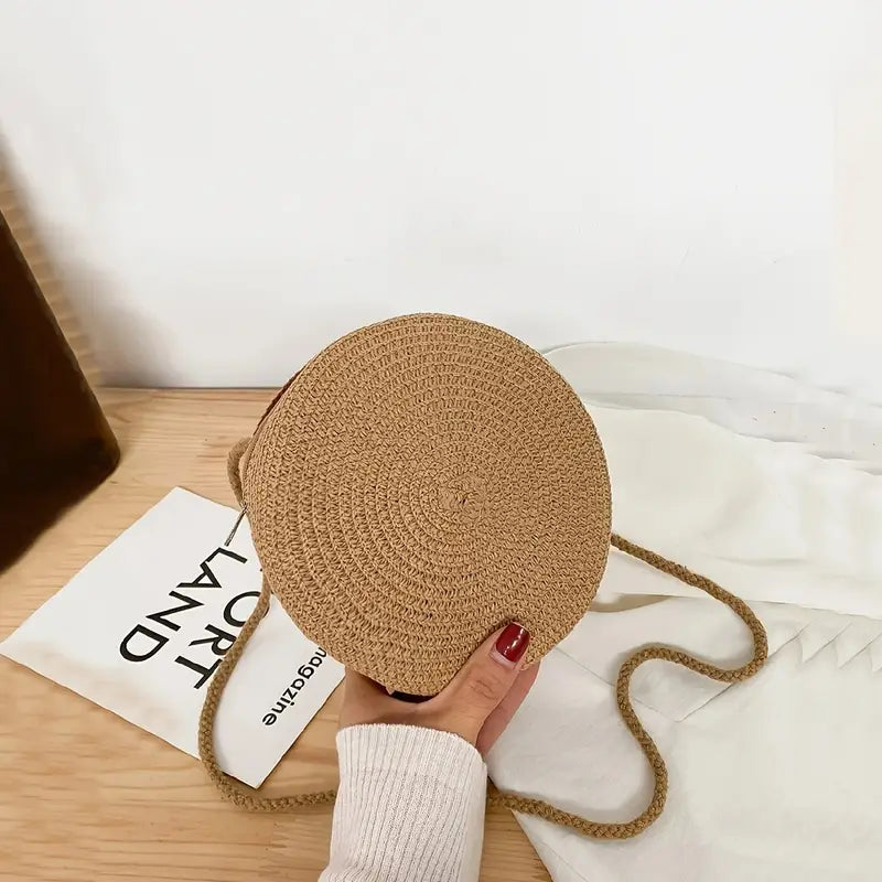 Round straw bag with zip closure and rope shoulder strap