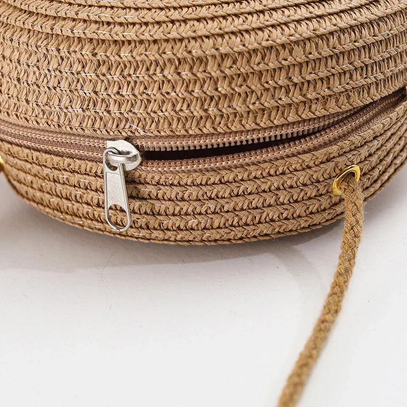 Round straw bag with zip closure and rope shoulder strap