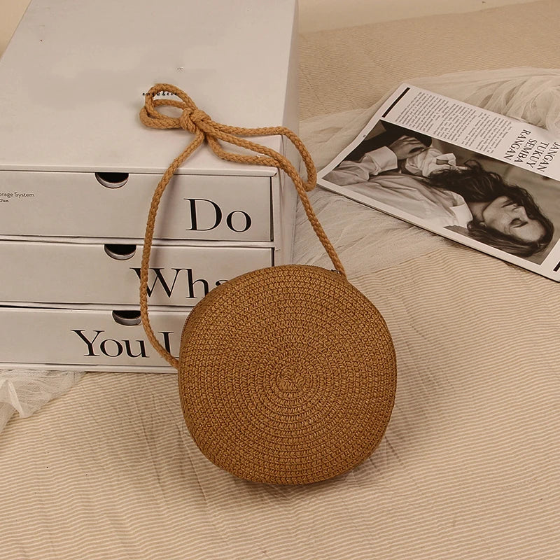 Round straw bag with zip closure and rope shoulder strap
