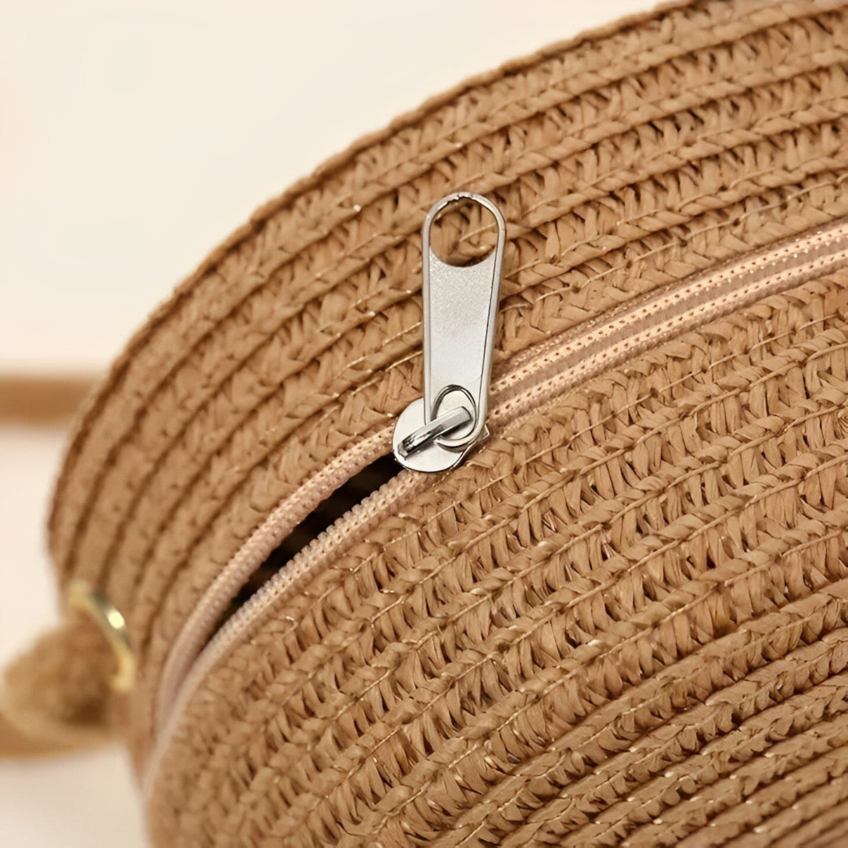 Round straw bag with zip closure and rope shoulder strap