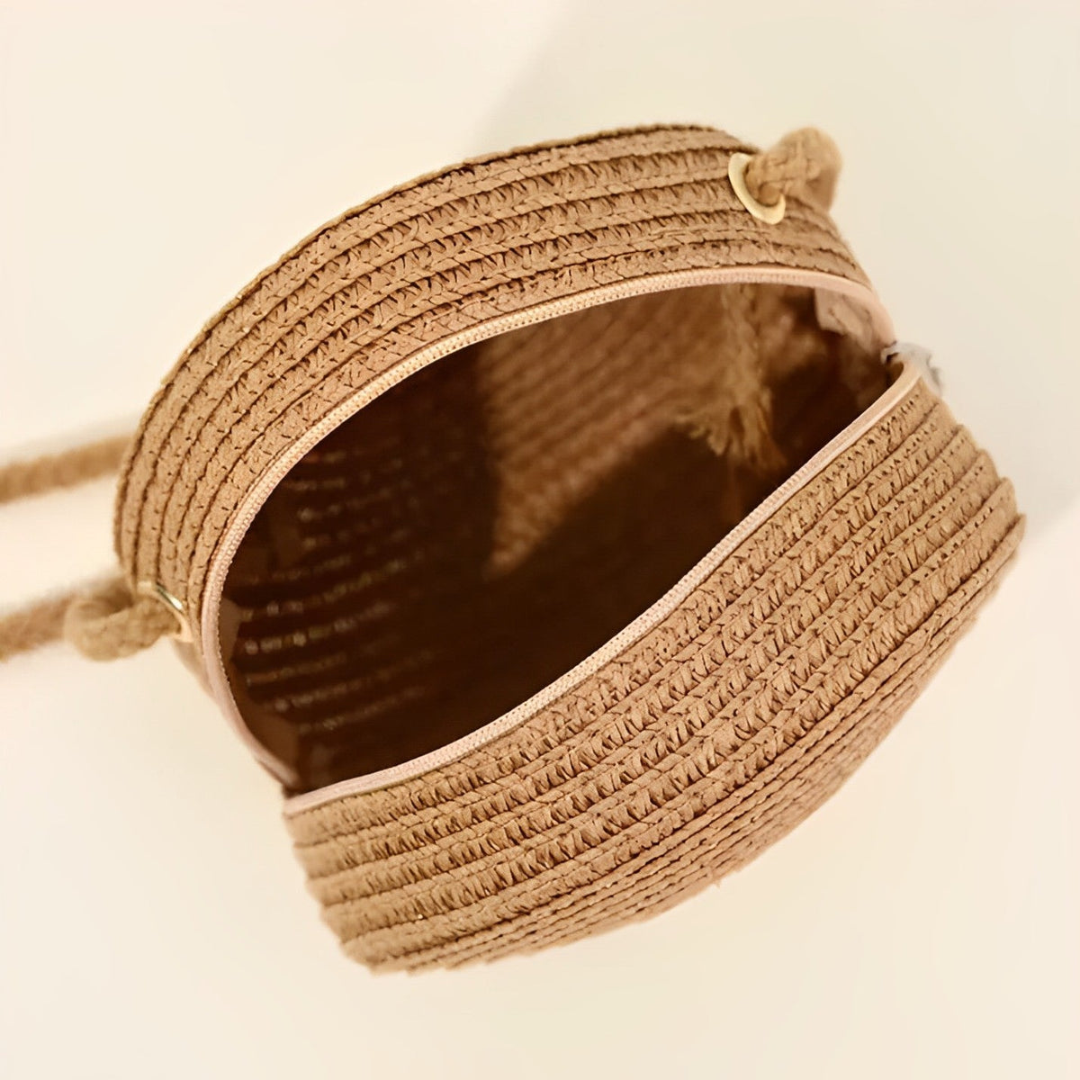Round straw bag with zip closure and rope shoulder strap