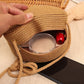 Round straw bag with zip closure and rope shoulder strap